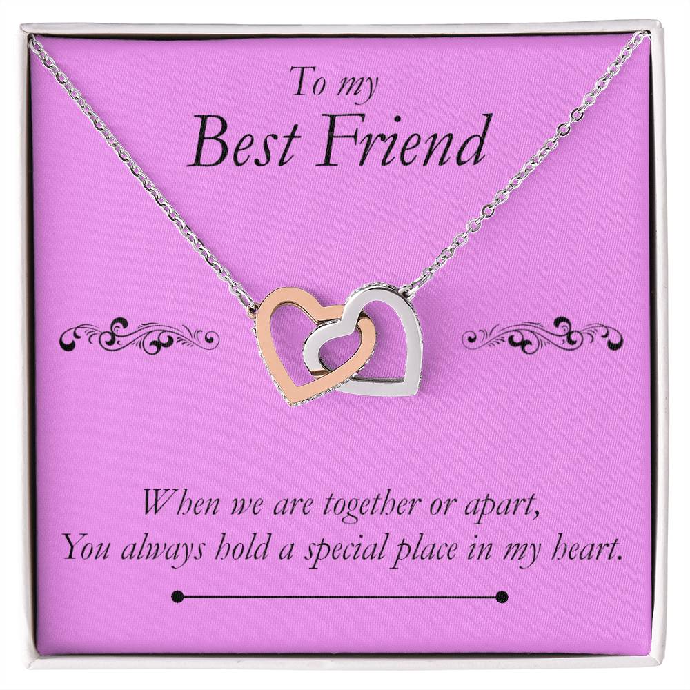 Best Friend Heart Necklace. A necklace with two pendant hearts interlocking in a box mounted on a card. The message reads: to my best friend. When we are together or apart, you always hold a special place in my heart.