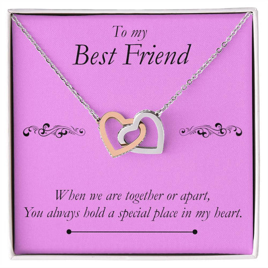 Best Friend Heart Necklace. A necklace with two pendant hearts interlocking in a box mounted on a card. The message reads: to my best friend. When we are together or apart, you always hold a special place in my heart.